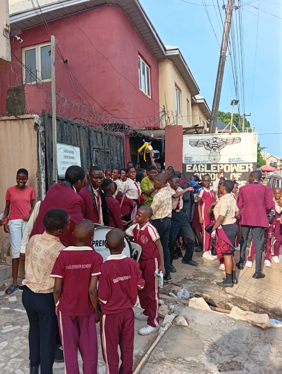 Pupils and students outside the Eagle Power school entrance in Awka